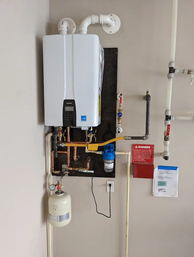 Professional plumber installing copper piping in a Nellis AFB home